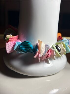 multi-colored stretch bracelet made from cut seashell pieces.